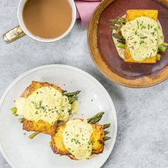 two plates with food on them next to a cup of coffee