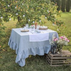 the table is set outside in the grass