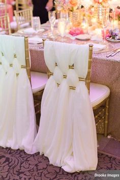 the chairs are covered with white chiffon sashes and gold trimmings