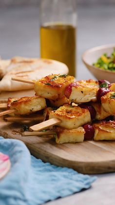 several skewers of food are on a cutting board