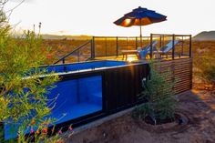 an outdoor hot tub in the desert at sunset