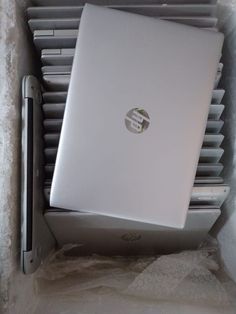 an open laptop computer sitting on top of a white box next to a heater