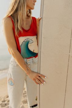 She’s really riding a wave in this funky tank! This tank was thrifted and patched then painted! I really loved the bright orange of this tank mixed with the blue of the wave! It gives all the summer feels and I’m here for it! This is a one of a kind item that was thrifted and painted! It may show signs of wear after multiple uses! Modeled on a Size: Small Earthy Style, Orange Tank Top, Thrifted Outfits, Painted Clothes, Summer Feeling, Refashion Clothes, The Wave, Outfit Goals, Hippie Style