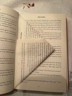 an open book with a piece of paper sticking out of it