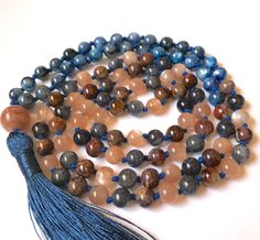 Kyanite Sunstone Pietersite Iolite 108 Mala Necklace Item Details: 30/6mm Kyanite 26/6mm Sunstone 26/6mm Pietersite 26/6mm Iolite 12mm Sunstone Guru Cotton Thread Handmade Rayon Silk Tassel Made with genuine natural material - only genuine material have the healing properties All my products are made with high quality beads from reliable sources and I take care to cleanse them and treat them with respect while I make the mala. Gemstones have their own vibrations, but also pick up energy as they Blue Natural Stone Beads For Meditation, Blue Natural Stones Beads For Meditation, Blue Gemstone Beads Mala As Gift, Spiritual Multicolor Hand Knotted Beaded Necklaces, Spiritual Multicolor Hand Knotted Beaded Necklace, Spiritual Multicolor Hand-knotted Beaded Necklaces, Multicolor Hand Knotted Beaded Necklaces For Meditation, Multicolor Hand Knotted Beaded Necklaces With Round Beads, Multicolor Hand-knotted Beaded Necklaces With Round Beads