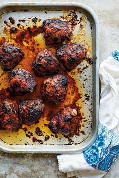 some meatballs are on a baking sheet and ready to be cooked in the oven