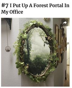 a mirror hanging on the side of a wall with plants growing out of it's frame