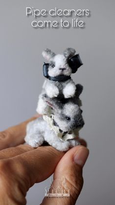 a hand holding a small stuffed animal in it's left hand with the caption, pipe cleaners come to life