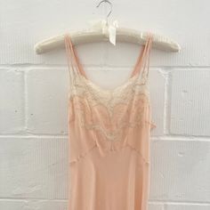 Stunning and unusual vintage 1930s slip gown in apricot. Maxi length, cut on the bias, it features triple spaghetti straps and a v-shaped neckline finished in floral champagne lace. Made from matte silk, it feels so light and luxurious on. - best on M or bigger S; model is size S and 5ft3'' - measurements in inches: chest 36'' / waist up to 28'' / length 58'' / hips 38''-40'' - 100% silk excluding lace trims - great condition with a few tiny marks Slip Gown, Lace Trims, Lace Slip, Lace Gown, V Shape, Bridesmaid Dress, Floral Lace, Apricot, Vintage Collection