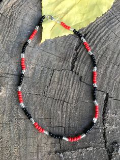 This is a glass seed bead necklace. the beads are 6mm. It is red and black. Adjustable Red Beaded Necklace With Black Beads, Adjustable Red Necklace With Black Beads, Adjustable Red And Black Beaded Necklace, Red Beaded Necklace With Silver Beads, Gift Red Beaded Necklaces With Black Beads, Red Beaded Necklaces With Black Beads For Gifts, Red And Black Beaded Necklaces For Gifts, Gift Red And Black Beaded Necklaces, Red And Black Beaded Necklace For Gift