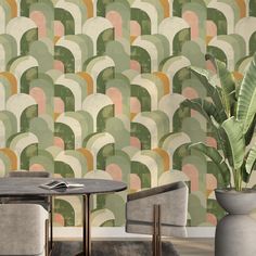 two chairs and a table in front of a wallpapered background with overlapping shapes