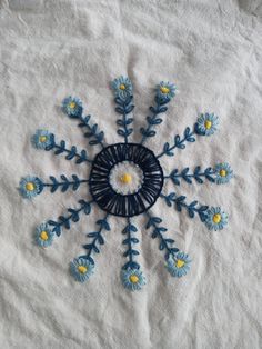 a blue and yellow snowflake on a white sheet