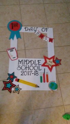 a sign that says middle school is on the floor with stars and pencils around it