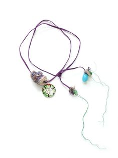 a necklace with beads and other items attached to it