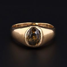 This unisex ring can be perfect for you or your significant other! This vintage ring (circa 1970-1980) is made up of 14k gold and features a forest green zircon gemstone with hints of brown. The ring is currently a size 6.25 and in good condition. It can be resized free of charge. Materials: zircon, 14k gold. Fine Jewelry 14k Gold Brown Ring, Brown 14k Gold Fine Jewelry Ring, Brown 14k Gold Rings Fine Jewelry, Classic 14k Gold Brown Ring, Classic Brown Signet Ring For Anniversary, Classic Brown Signet Ring, Formal Brown 14k Gold Rings, Elegant Brown Signet Ring For Anniversary, Brown Topaz Ring