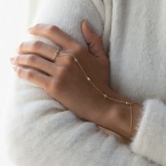 Dainty and minimal, but never understated. This handchain bracelet is made with five tiny pave crystals linked to a delicate chain that shimmers with every move. Comfortable to wear for long periods, you'll never want to take this off! Thick layer of 14K Gold over Sterling Silver Cubic Zirconia pave crystals, 3mm Hypoallergenic, lead and nickel free Wrist Chain Length: 5.75-6.75in (14.6-17cm), 6.75-7.75in (17-20cm) Palm Chain Length: 4in (10.2cm) Handcrafted in NYC #B298 2-3 Business Days Classy Hand Rings, Delicate Chain Ring, Hand Rings Simple, Hands Full Of Bracelets, Cheap Elegant Hand Wrapped Jewelry, Hand For Jewelry, Rose Gold Stackable Rings, Hand Chain Jewelry, Wrist Chain