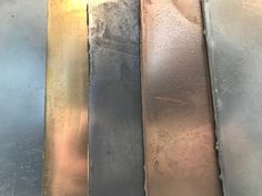 four different colors of metal sitting on top of each other