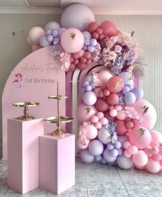 a pink birthday party with balloons and decorations