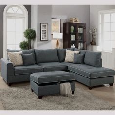 a living room with a sectional couch and ottoman