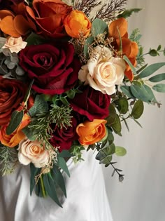 a bridal bouquet with orange and red flowers