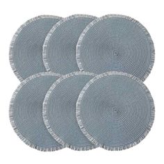 four round woven placemats with fringe on each side, in grey and white