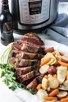 a white plate topped with meat, potatoes and carrots next to an instant pot roast