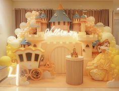 a castle with balloons and princess figures on the front, surrounded by other items for decoration