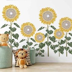 the sunflowers are painted on the wall and there is a stuffed animal in front