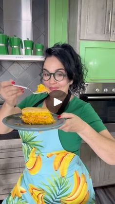 a woman is eating corn on the cob with a spoon in her hand and wearing glasses