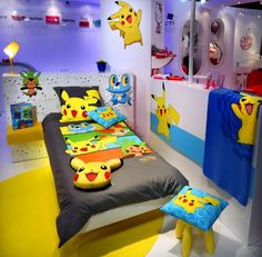 the pokemon bedroom is decorated in blue, yellow and red colors with pikachu pillows