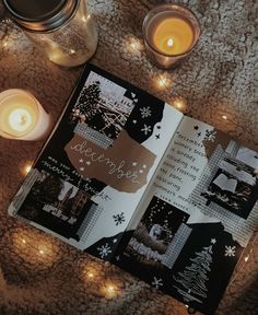 an open book sitting on top of a blanket next to candles and some glass jars