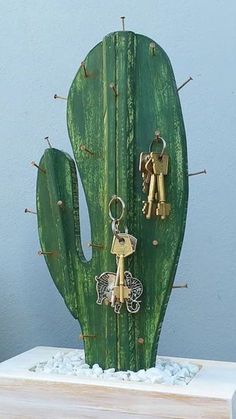 a green cactus with keys attached to it