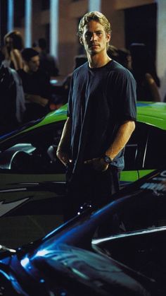 a man standing in front of some cars