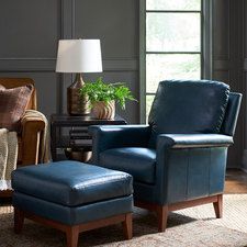 a blue chair and ottoman in a living room