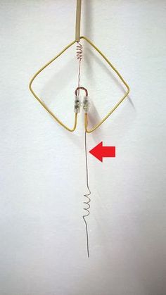 an electrical device with wires attached to the back of it and two red arrows pointing in opposite directions