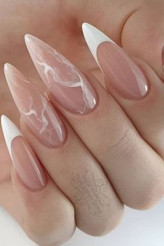 Enter a realm of sophistication with nails that resemble the intricate patterns of marble. The blend of translucent whites and delicate pinks creates a mesmerizing effect, akin to the natural veining of stone. These nails are for the individual who finds beauty in the details and seeks nail ideas that are as nuanced as their personality. Steledio Nails, Nails Stilleto Short, Stiletto Nails White Designs, Medium Stilleto Nails Almond, Nail Stelitto Ideas, Nails Stelitto, Cute Nails Stiletto, Classy Stilleto Nails, Natural Marble Nails