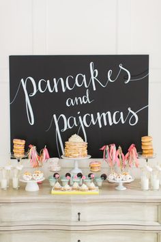 a dessert table with cookies and pastries on it