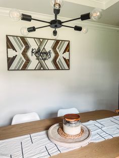 a wooden table topped with a cake on top of a white cloth covered placemat