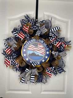 a wreath on the front door decorated with american flags and other decorations for veterans day