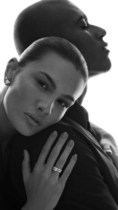 two women are posing for the camera in black and white