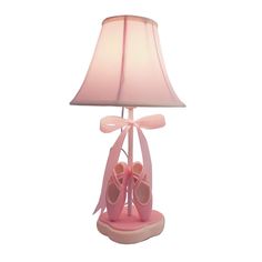 a lamp that has pink shoes on it with a light shade over the top and bottom