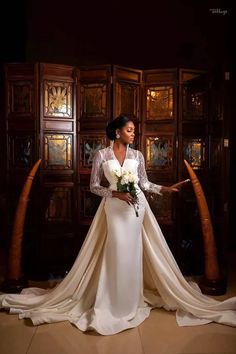 a woman in a wedding dress holding flowers