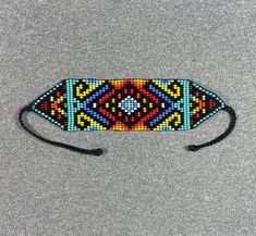 a colorful beaded headband on a gray surface