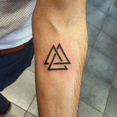 a man's arm with a triangle tattoo on the left side of his arm