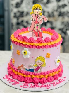 a pink and yellow birthday cake with a cartoon figure on top