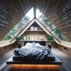 an attic bedroom with a bed and bookshelf