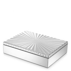 a silver box sitting on top of a white surface