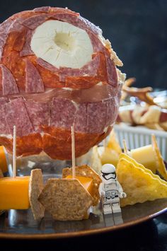 a star wars ham ball on a plate with cheese and crackers