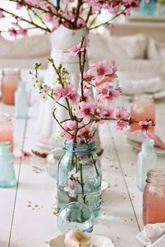 a vase filled with pink flowers sitting on top of a table