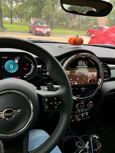 the interior of a car with an electronic display and steering wheel, dashboard lights, and dash board